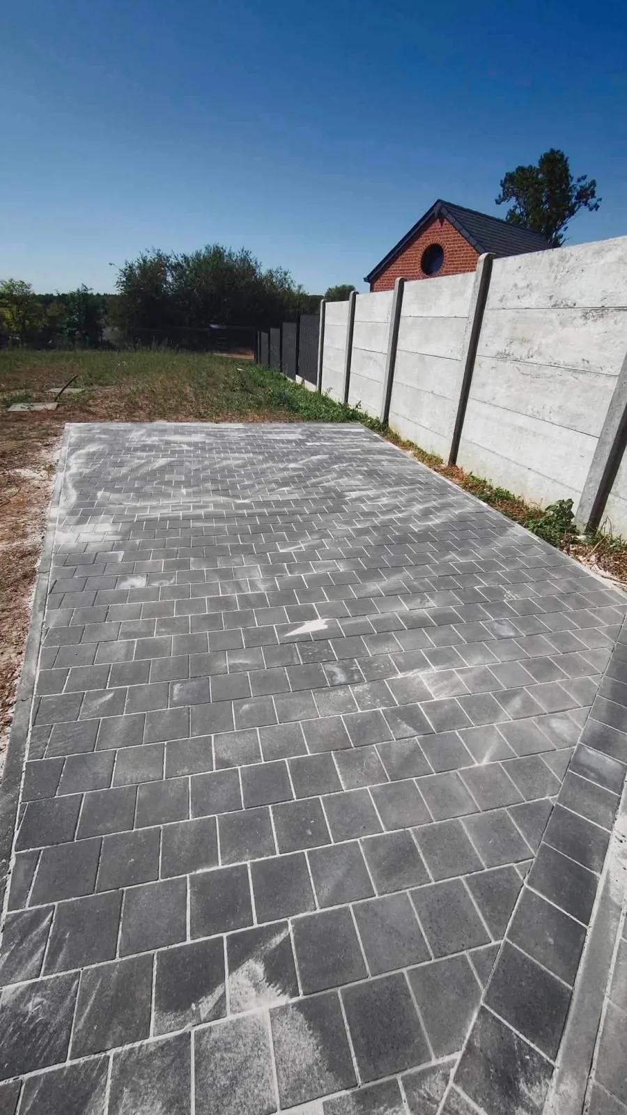 Allée pavée le long d'un mur en béton